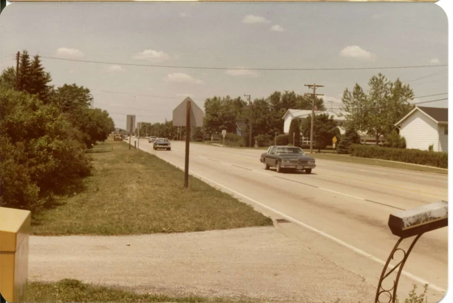 Traffic moving along Euclid Avenue at Burning Bush Lane in Mount Prospect in summer 1979