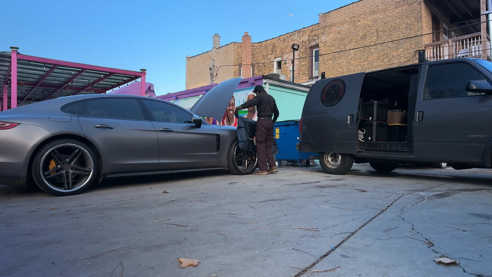 Grease Nomads technician inspecting a vehicle beside the mobile service van