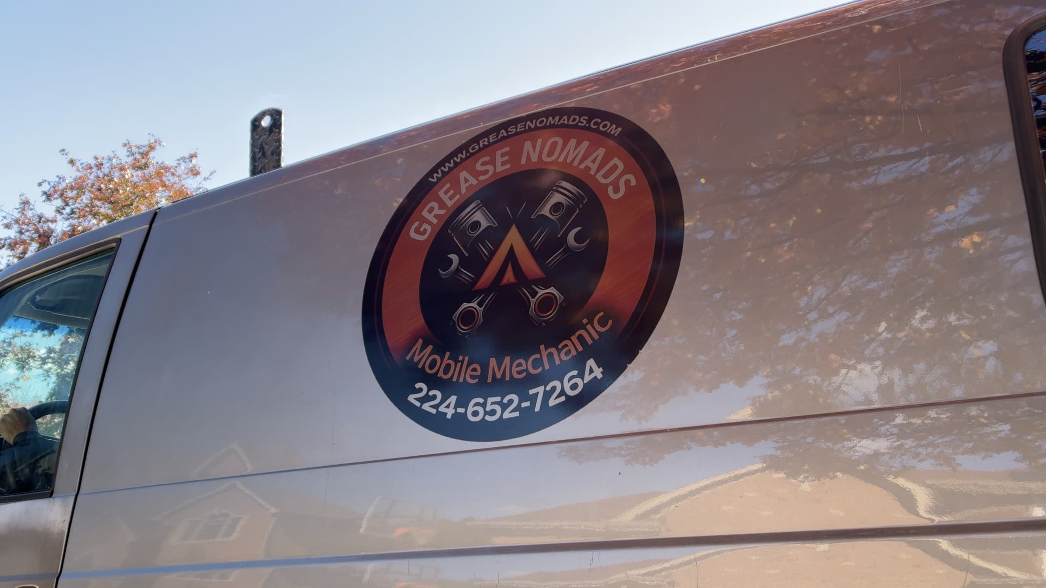Grease Nomads logo and phone number displayed on the side of the service van